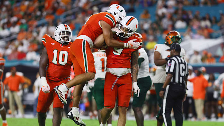Sep 7, 2024; Miami Gardens, Florida, USA; Miami Hurricanes defensive lineman Tyler Baron (9) celebrates with teammates after sacking Florida A&M Rattlers quarterback Daniel Richardson (not pictured) during the third quarter at Hard Rock Stadium. Mandatory Credit: Sam Navarro-Imagn Images