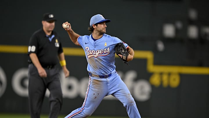 Sep 7, 2025; Arlington, Texas, USA; Texas Rangers shortstop Josh Smith (8) throws the ball during the game between the Texas Rangers and the Houston Astros at Globe Life Field. Mandatory Credit: Jerome Miron-Imagn Images