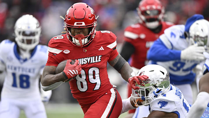 Nov 29, 2025; Louisville, Kentucky, USA;  Louisville Cardinals wide receiver Shaun Boykins Jr. (89) runs the ball against Kentucky Wildcats defensive back Ty Bryant (14) during the second half at L&N Federal Credit Union Stadium. Louisville defeated Kentucky 41-0. Mandatory Credit: Jamie Rhodes-Imagn Images