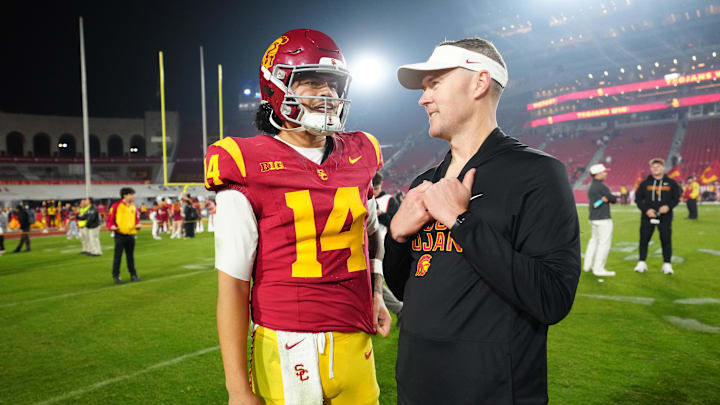 Nov 29, 2025; Los Angeles, California, USA; Southern California Trojans quarterback Jayden Maiava (14) and head coach Lincoln Riley react after the game against the UCLA Bruins at United Airlines Field at Los Angeles Memorial Coliseum. Mandatory Credit: Kirby Lee-Imagn Images