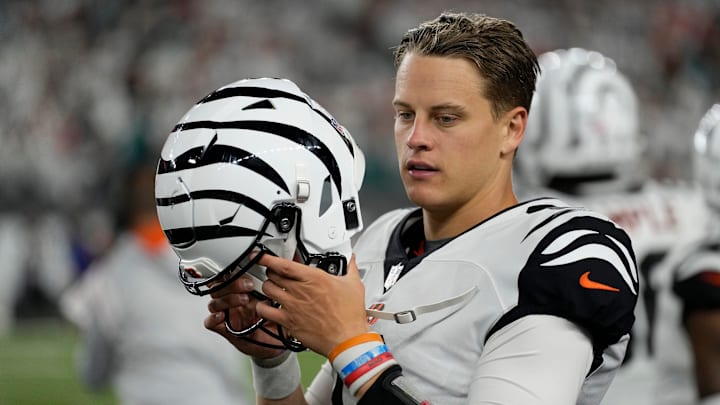 Cincinnati Bengals quarterback Joe Burrow (9) puts on his helmet to run out the final minute of the fourth quarter of the NFL Week 4 game between the Cincinnati Bengals and the Miami Dolphins at PayCor Stadium in downtown on Thursday, Sept. 29, 2022. The Bengals improved to 2-2 with a 27-15 win over the Dolphins.

Miami Dolphins At Cincinnati Bengals Week 4