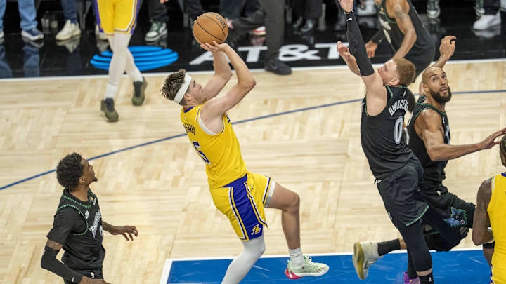 Oct 29, 2025; Minneapolis, Minnesota, USA; Los Angeles Lakers guard Austin Reaves (15) shoots a game winning shot over Minnesota Timberwolves guard Donte DiVincenzo (0) in the second half at Target Center. Mandatory Credit: Jesse Johnson-Imagn Images Oct 29, 2025; Minneapolis, Minnesota, USA; Los Angeles Lakers guard Austin Reaves (15) shoots a game winning shot over Minnesota Timberwolves guard Donte DiVincenzo (0) in the second half at Target Center. Mandatory Credit: Jesse Johnson-Imagn Images