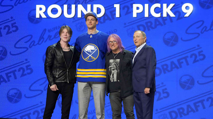 Jun 27, 2025; Los Angeles, California, USA; Radim Mrtka (second from left) poses with John Rzeznik (left) and Robby Takac (second from right) of the Goo Goo Dolls and NHL commissioner Gary Bettman (right) after being selected  as the ninth overall pick to the Buffalo Sabres in the first round of the 2025 NHL Draft at Peacock Theater. Mandatory Credit: Kirby Lee-Imagn Images