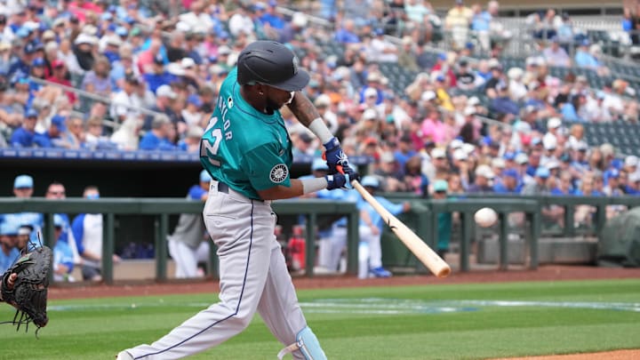 Seattle Mariners second baseman Samad Taylor (12) hits a home run against the Kansas City Royals during the third inning at Surprise Stadium in 2024.