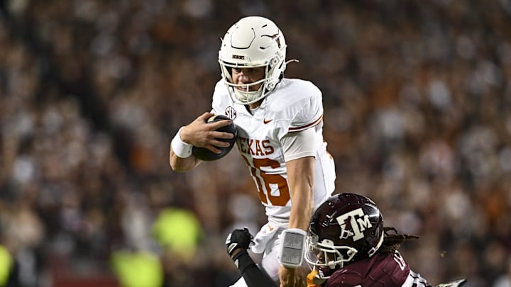 Texas Longhorns quarterback Arch Manning runs the ball against the Texas A&M Aggies Texas Longhorns quarterback Arch Manning runs the ball against the Texas A&M Aggies