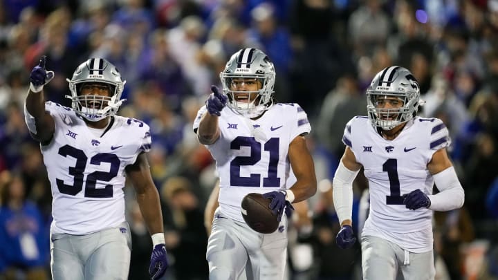 Nov 18, 2023; Lawrence, Kansas, USA; Kansas State Wildcats safety Marques Sigle (21) celebrates with linebacker Desmond Purnell (32) and cornerback Keenan Garber (1) after an interception during the second half against the Kansas Jayhawks at David Booth Kansas Memorial Stadium. Mandatory Credit: Jay Biggerstaff-USA TODAY Sports Nov 18, 2023; Lawrence, Kansas, USA; Kansas State Wildcats safety Marques Sigle (21) celebrates with linebacker Desmond Purnell (32) and cornerback Keenan Garber (1) after an interception during the second half against the Kansas Jayhawks at David Booth Kansas Memorial Stadium. Mandatory Credit: Jay Biggerstaff-USA TODAY Sports