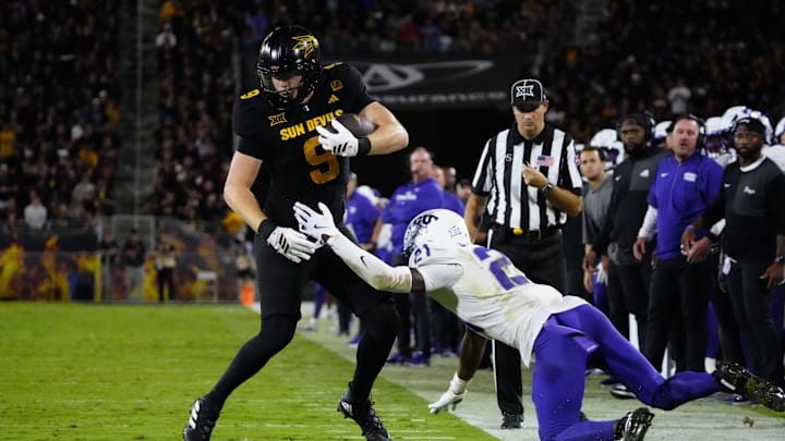 Arizona State tight end Cameron Harpole (9) jukes TCU safety Bud Clark (21) during a game against TCU at Mountain America Stadium in Tempe on Sept. 26, 2025. Arizona State tight end Cameron Harpole (9) jukes TCU safety Bud Clark (21) during a game against TCU at Mountain America Stadium in Tempe on Sept. 26, 2025.