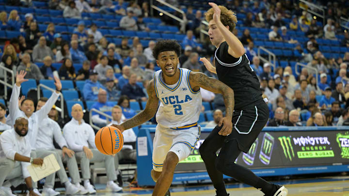 Dec 19, 2025; Los Angeles, California, USA; UCLA Bruins guard Donovan Dent (2) is fouled by Cal Poly Mustangs guard Guzman Vasilic (5) during the first half at Pauley Pavilion presented by Wescom Financial. Mandatory Credit: Jayne Kamin-Oncea-Imagn Images