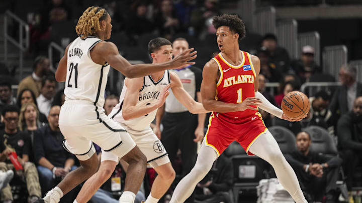 Feb 22, 2026; Atlanta, Georgia, USA; Atlanta Hawks forward Jalen Johnson (1) handles the ball against Brooklyn Nets forward Noah Clowney (21) and guard Egor Demin (8) during the first half at State Farm Arena. Mandatory Credit: Dale Zanine-Imagn Images