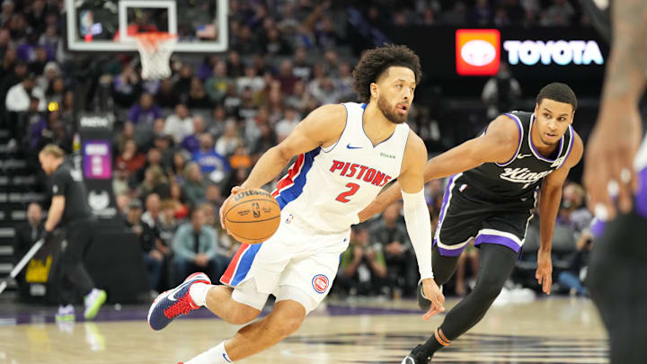 Dec 26, 2024; Sacramento, California, USA; Detroit Pistons guard Cade Cunningham (2) drives in against Sacramento Kings forward Keegan Murray (13) during the first quarter at Golden 1 Center. Mandatory Credit: Kelley L Cox-Imagn Images