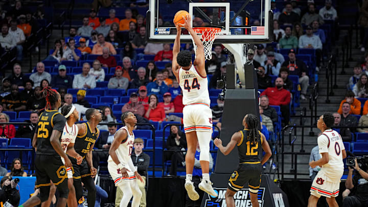 Mar 20, 2025; Lexington, KY, USA;  Auburn Tigers center Dylan Cardwell (44) dunks the ball during the second half against the Alabama State Hornets in the first round of the NCAA Tournament at Rupp Arena. Mandatory Credit: Aaron Doster-Imagn Images