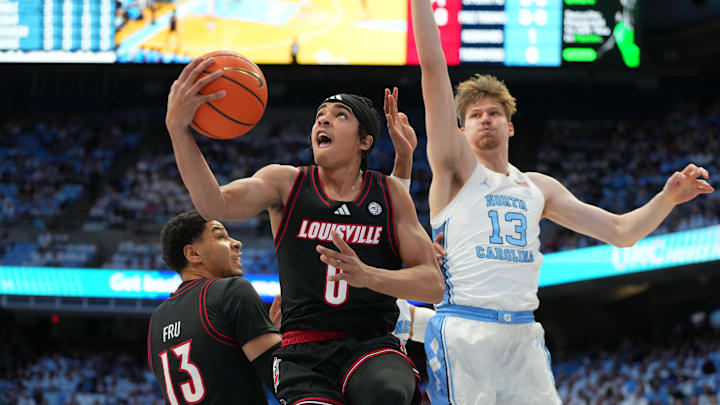 Feb 23, 2026; Chapel Hill, North Carolina, USA; Louisville Cardinals guard Mikel Brown Jr. (0) shoots as North Carolina Tar Heels center Henri Veesaar (13) defends in the first half at Dean E. Smith Center. Mandatory Credit: Bob Donnan-Imagn Images