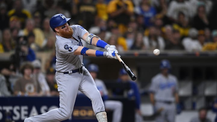 Oct 15, 2022; San Diego, California, USA; Los Angeles Dodgers third baseman Justin Turner (10) hits a single in the second inning against the San Diego Padres during game four of the NLDS for the 2022 MLB Playoffs at Petco Park. Mandatory Credit: Orlando Ramirez-Imagn Images