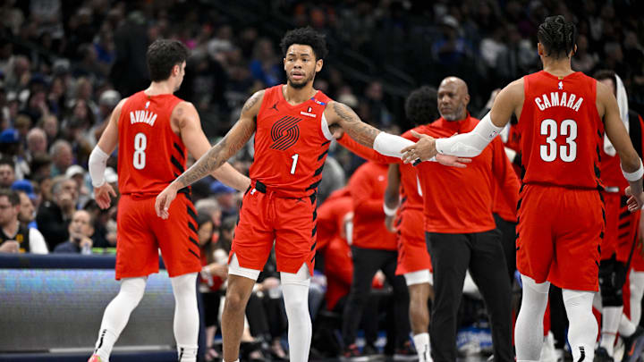 Dec 23, 2024; Dallas, Texas, USA; Portland Trail Blazers forward Deni Avdija (8) and guard Anfernee Simons (1) and forward Toumani Camara (33) walk back to the bench during the second quarter against the Dallas Mavericks at the American Airlines Center. Mandatory Credit: Jerome Miron-Imagn Images Dec 23, 2024; Dallas, Texas, USA; Portland Trail Blazers forward Deni Avdija (8) and guard Anfernee Simons (1) and forward Toumani Camara (33) walk back to the bench during the second quarter against the Dallas Mavericks at the American Airlines Center. Mandatory Credit: Jerome Miron-Imagn Images