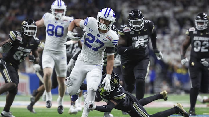 Dec 28, 2024; San Antonio, TX, USA; Brigham Young Cougars running back LJ Martin (27) runs with the ball as Colorado Buffaloes cornerback Colton Hood (3) attempts to make a tackle during the fourth quarter at Alamodome. Mandatory Credit: Troy Taormina-Imagn Images Dec 28, 2024; San Antonio, TX, USA; Brigham Young Cougars running back LJ Martin (27) runs with the ball as Colorado Buffaloes cornerback Colton Hood (3) attempts to make a tackle during the fourth quarter at Alamodome. Mandatory Credit: Troy Taormina-Imagn Images