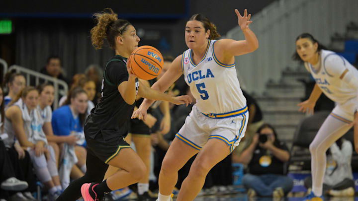 Dec 16, 2025; Los Angeles, California, USA; Cal Poly Mustangs guard Alana Goosby (22) is defended by UCLA Bruins guard Charlisse Leger-Walker (5) during the first half at Pauley Pavilion presented by Wescom Financial. Mandatory Credit: Jayne Kamin-Oncea-Imagn Images Dec 16, 2025; Los Angeles, California, USA; Cal Poly Mustangs guard Alana Goosby (22) is defended by UCLA Bruins guard Charlisse Leger-Walker (5) during the first half at Pauley Pavilion presented by Wescom Financial. Mandatory Credit: Jayne Kamin-Oncea-Imagn Images