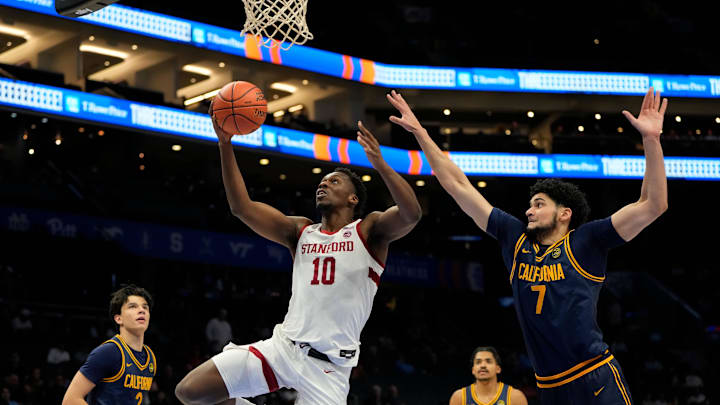 Mar 12, 2025; Charlotte, NC, USA; Stanford Cardinal forward Chisom Okpara (10) shoots as California Golden Bears forward Spencer Mahoney (7) defends in the first half at Spectrum Center. Mandatory Credit: Bob Donnan-Imagn Images