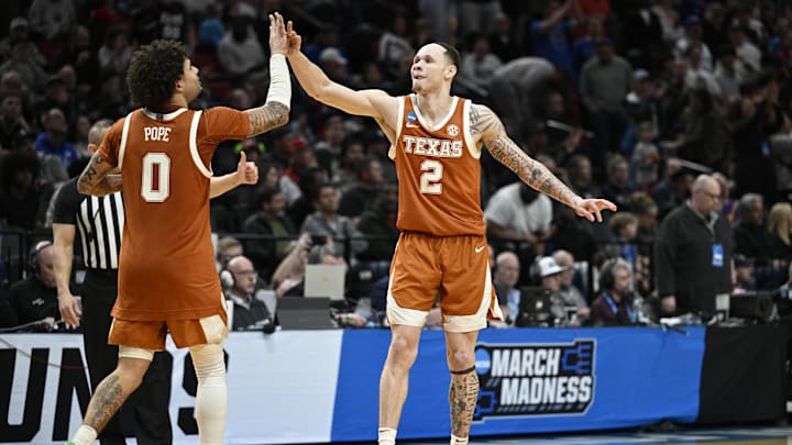 Mar 19, 2026; Portland, OR, USA; Texas Longhorns guard Chendall Weaver (2) celebrates with guard Jordan Pope (0) against the BYU Cougars in a first-round game of the NCAA Tournament.