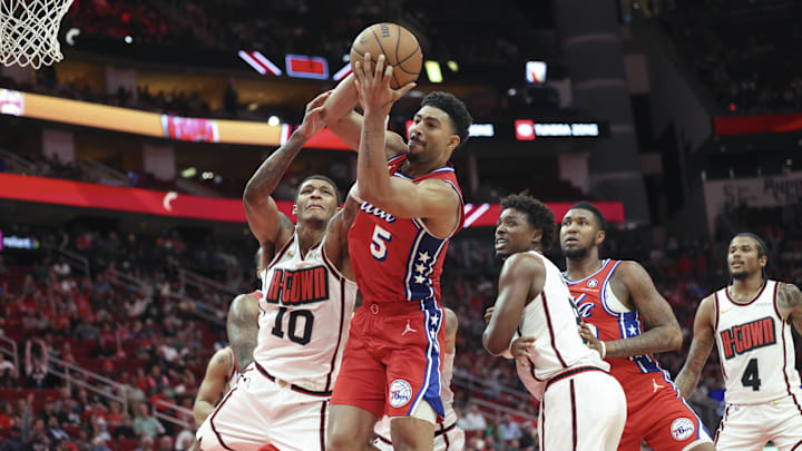 Mar 17, 2025; Houston, Texas, USA; Philadelphia 76ers guard Quentin Grimes (5) attempts to control a rebound away from Houston Rockets forward Jabari Smith Jr. (10) during the fourth quarter at Toyota Center. Mandatory Credit: Troy Taormina-Imagn Images