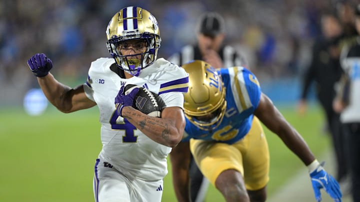 Nov 22, 2025; Pasadena, California, USA;  Washington Huskies running back Jordan Washington (4) is forced out of bounds after a 9-yard gain during the first half against the UCLA Bruins at the Rose Bowl. Mandatory Credit: Jayne Kamin-Oncea-Imagn Images