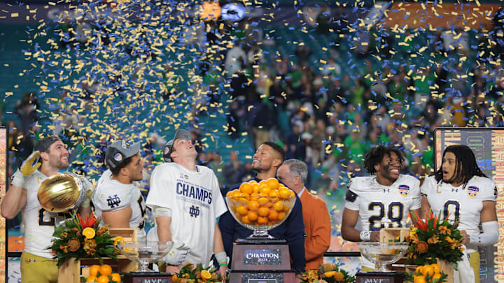 Jan 9, 2025; Miami, FL, USA; Notre Dame Fighting Irish head coach Micah Shrewsberry and quarterback Riley Leonard (13) celebrates defeating the Penn State Nittany Lions  in the Orange Bowl at Hard Rock Stadium. Mandatory Credit: Sam Navarro-Imagn Images