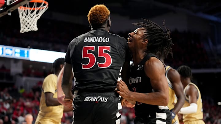 Cincinnati Bearcats guard Day Day Thomas (1) congratulates Cincinnati Bearcats forward Aziz Bandaogo (55) on a made basket and a drawn foul in the second half during an NCAA college basketball game between Georgia Tech Yellow Jackets and the Cincinnati Bearcats, Wednesday, Nov. 22, 2023, at Fifth Third Arena in Cincinnati. Cincinnati Bearcats guard Day Day Thomas (1) congratulates Cincinnati Bearcats forward Aziz Bandaogo (55) on a made basket and a drawn foul in the second half during an NCAA college basketball game between Georgia Tech Yellow Jackets and the Cincinnati Bearcats, Wednesday, Nov. 22, 2023, at Fifth Third Arena in Cincinnati.