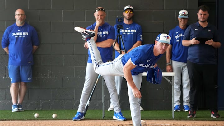 Feb 16, 2025; Dunedin, FL, USA; Toronto Blue Jays pitcher Chris Bassitt (40) throws a pitch as Blue Jays coaching staff looks on during spring training practice at TD Ballpark. Mandatory Credit: Dave Nelson-Imagn Images