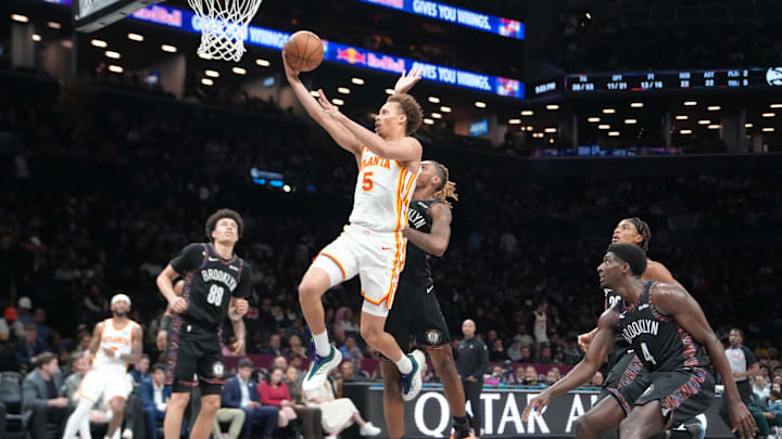 Apr 3, 2026; Brooklyn, New York, USA; Atlanta Hawks guard Dyson Daniels (5) shoots a layup against Brooklyn Nets forward Noah Clowney (21) during the second half at Barclays Center. Mandatory Credit: Gregory Fisher-Imagn Images