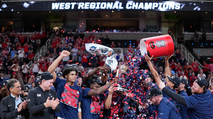 Mar 28, 2026; San Jose, CA, USA; The Arizona Wildcats celebrate with the West Regional Championship trophy after an Elite Eight game against the Purdue Boilermakers of the West Regional of the men's 2026 NCAA Tournament at SAP Center. Mandatory Credit: Kyle Terada-Imagn Images