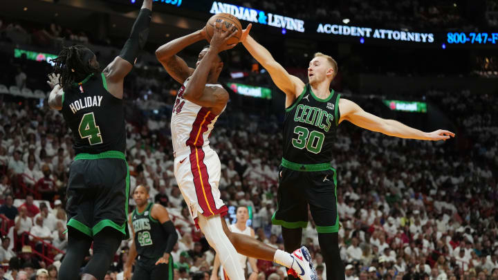 Apr 27, 2024; Miami, Florida, USA; Miami Heat forward Haywood Highsmith (24) drives to the basket as Boston Celtics guard Jrue Holiday (4) and forward Sam Hauser (30) defend in the first half during game three of the first round for the 2024 NBA playoffs at Kaseya Center. Mandatory Credit: Jim Rassol-USA TODAY Sports