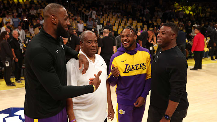 Los Angeles Lakers forward LeBron James (23) and his son, guard Bronny James (9) talk to former Major League Baseball players Ken Griffey, Sr. and Ken Griffey, Jr. before a game against the Minnesota Timberwolves at Crypto.com Arena on Oct 22.