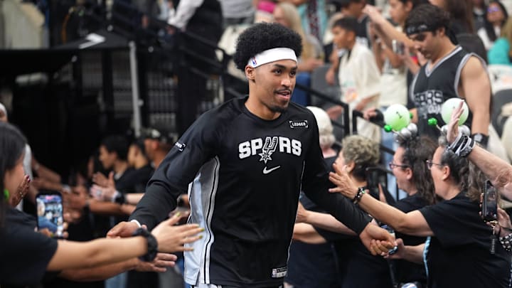 Apr 12, 2026; San Antonio, Texas, USA; San Antonio Spurs guard Dylan Harper (2) greets fans while entering the court before a game against the Denver Nuggets at Frost Bank Center. Mandatory Credit: Scott Wachter-Imagn Images