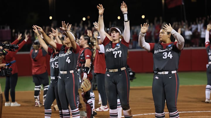 May 24, 2025; Fayetteville, AR, USA; Arkansas Razorbacks  first baseman Bri Ellis (77) calls the Hogs with teammates after defeating Ole Miss Rebels in game two of the Fayetteville Super Regional at Bogle Park. Arkansas won 4-0. Mandatory Credit: Nelson Chenault-Imagn Images