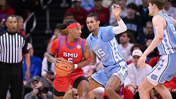 Jan 3, 2026; Dallas, Texas, USA; SMU Mustangs guard Jaron Pierre Jr. (5) controls the ball in front of North Carolina Tar Heels forward Jarin Stevenson (15) during the game between the Mustangs and the Tar Heels at Moody Coliseum. Mandatory Credit: Jerome Miron-Imagn Images
