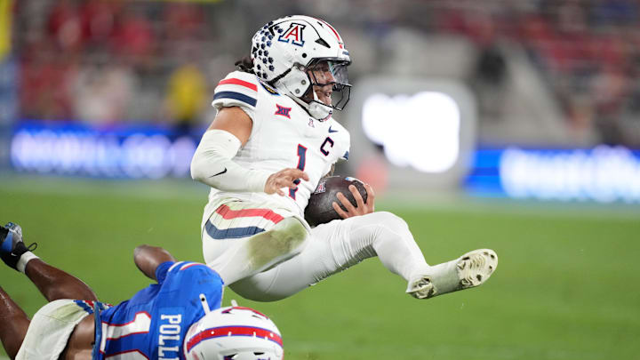 Jan 2, 2026; San Diego, CA, USA; Arizona Wildcats quarterback Noah Fifita (1) is tackled by SMU Mustangs safety Tyren Polley (10) in the second half during the Holiday Bowl at Snapdragon Stadium. Mandatory Credit: Kirby Lee-Imagn Images