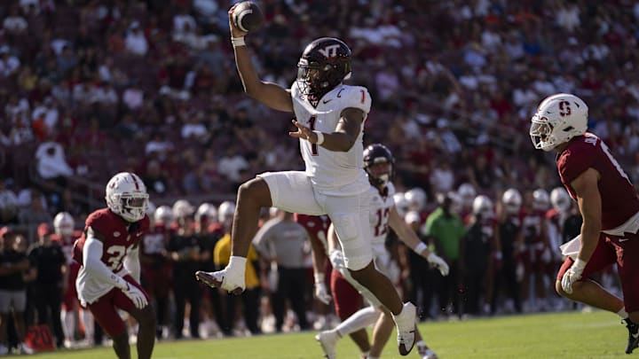 Oct 5, 2024; Stanford, California, USA;  Virginia Tech Hokies quarterback Kyron Drones (1) leaps into the end zone against the Stanford Cardinal during the fourth quarter at Stanford Stadium. Mandatory Credit: Stan Szeto-Imagn Images