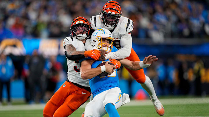 Cincinnati Bengals linebacker Akeem Davis-Gaither (59) and linebacker Logan Wilson (55) wrap up Los Angeles Chargers quarterback Justin Herbert (10) for a sack in the third quarter of the NFL Week 11 game between the Los Angeles Chargers and the Cincinnati Bengals at SoFi Stadium in Inglewood, Calif., on Sunday, Nov. 17, 2024. The Chargers won 34-27. Cincinnati Bengals linebacker Akeem Davis-Gaither (59) and linebacker Logan Wilson (55) wrap up Los Angeles Chargers quarterback Justin Herbert (10) for a sack in the third quarter of the NFL Week 11 game between the Los Angeles Chargers and the Cincinnati Bengals at SoFi Stadium in Inglewood, Calif., on Sunday, Nov. 17, 2024. The Chargers won 34-27.