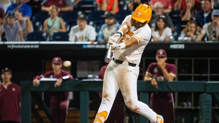 Jun 14, 2024; Omaha, NE, USA; Tennessee Volunteers first baseman Blake Burke (25) hits a 2 RBI single against the Florida State Seminoles during the ninth inning at Charles Schwab Filed Omaha. Mandatory Credit: Dylan Widger-USA TODAY Sports