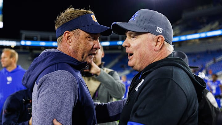 Oct 26, 2024; Lexington, Kentucky, USA; Auburn Tigers head coach Hugh Freeze talks with Kentucky Wildcats head coach Mark Stoops after the game at Kroger Field. Mandatory Credit: Jordan Prather-Imagn Images