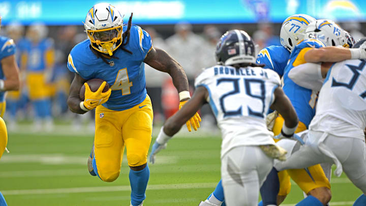 Nov 10, 2024; Inglewood, California, USA; Los Angeles Chargers running back Gus Edwards (4) carries the ball for a first down before he is stopped by Tennessee Titans cornerback Jarvis Brownlee Jr. (29) in the first half at SoFi Stadium. Mandatory Credit: Jayne Kamin-Oncea-Imagn Images Nov 10, 2024; Inglewood, California, USA; Los Angeles Chargers running back Gus Edwards (4) carries the ball for a first down before he is stopped by Tennessee Titans cornerback Jarvis Brownlee Jr. (29) in the first half at SoFi Stadium. Mandatory Credit: Jayne Kamin-Oncea-Imagn Images
