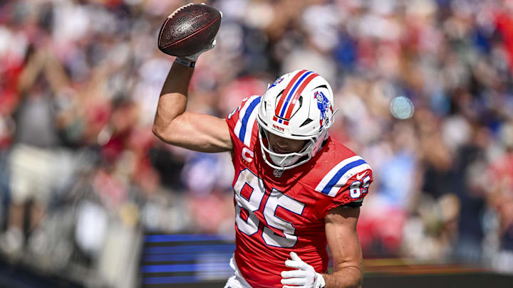 New England Patriots tight end Hunter Henry (85) spikes the ball after scoring a touchdown during the fourth quarter at Gillette Stadium.