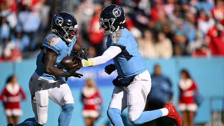 Dec 21, 2025; Nashville, Tennessee, USA; Tennessee Titans quarterback Cam Ward (1) hands off to running back Tyjae Spears (2) during the first half against the Kansas City Chiefs at Nissan Stadium. Mandatory Credit: Steve Roberts-Imagn Images