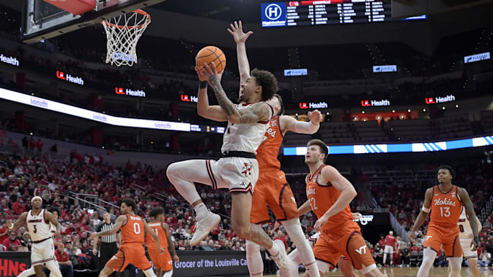 Jan 24, 2026; Louisville, Kentucky, USA;  Louisville Cardinals guard J'vonne Hadley (1) shoots against Virginia Tech Hokies guard Neoklis Avdalas (17) during the first half at KFC Yum! Center. Mandatory Credit: Jamie Rhodes-Imagn Images