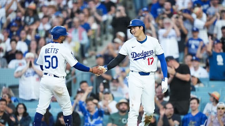 Jul 3, 2025; Los Angeles, California, USA; Los Angeles Dodgers designated hitter Shohei Ohtani (17) celebrates with Los Angeles Dodgers shortstop Mookie Betts (50) after scoring a run during the third inning against the Chicago White Sox at Dodger Stadium. Mandatory Credit: Kirby Lee-Imagn Images