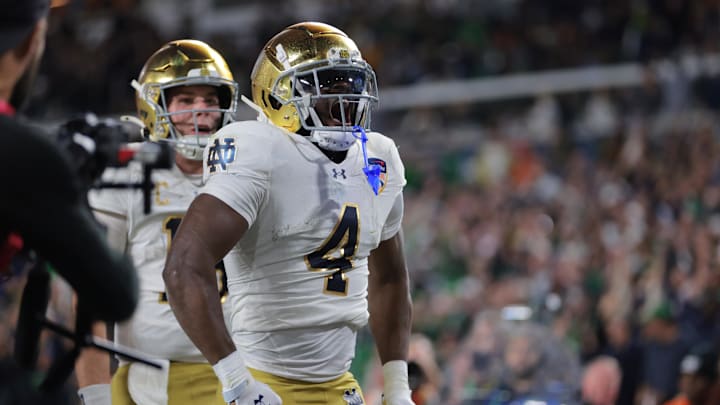 Jan 9, 2025; Miami, FL, USA; Notre Dame Fighting Irish running back Jeremiyah Love (4) celebrates a touch down in the second half against the Penn State Nittany Lions in the Orange Bowl at Hard Rock Stadium. 