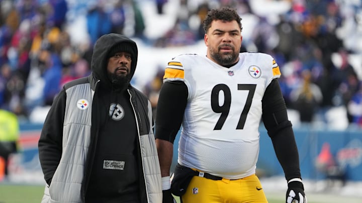 Jan 15, 2024; Orchard Park, New York, USA; Pittsburgh Steelers head coach Mike Tomlin walks the field with  defensive tackle Cameron Heyward (97) before the game against the Buffalo Bills in a 2024 AFC wild card game at Highmark Stadium. Mandatory Credit: Kirby Lee-Imagn Images