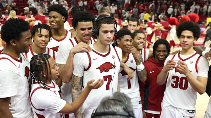 Dec 3, 2025; Fayetteville, Arkansas, USA; Arkansas Razorbacks forward Trevon Brazile (7) surrounded by teammates, talks to broadcasters after a game against Louisville Cardinals at Bud Walton Arena. Arkansas won 89-80. Mandatory Credit: Nelson Chenault-Imagn Images