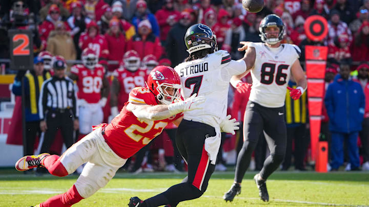 Dec 21, 2024; Kansas City, Missouri, USA; Houston Texans quarterback C.J. Stroud (7) throws to tight end Dalton Schultz (86) as Kansas City Chiefs linebacker Drue Tranquill (23) defends during the first half at GEHA Field at Arrowhead Stadium. Mandatory Credit: Denny Medley-Imagn Images