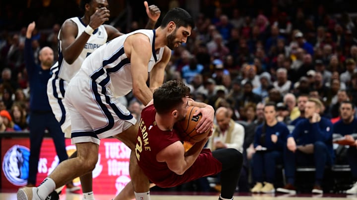 Feb 23, 2025; Cleveland, Ohio, USA; Memphis Grizzlies forward Santi Aldama (7) and Cleveland Cavaliers guard Ty Jerome (2) fight for possession during the second half at Rocket Arena. Mandatory Credit: Ken Blaze-Imagn Images