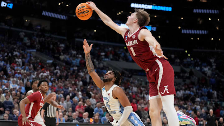 Mar 28, 2024; Los Angeles, CA, USA; Alabama Crimson Tide forward Grant Nelson (2) blocks North Carolina's RJ Davis (4) in the fleeting seconds of the game to save Alabama'a lead.